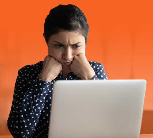 Concerned woman looking at laptop