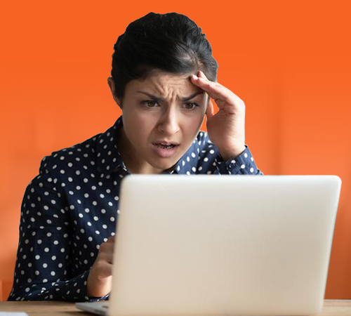 Shocked woman looking at laptop